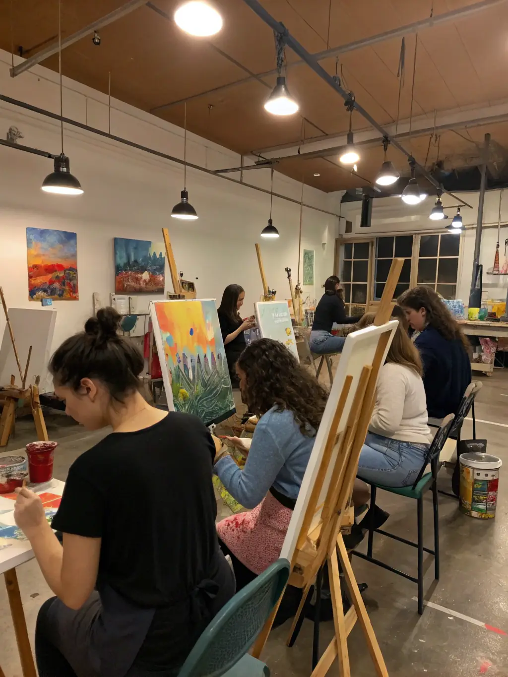 A cozy winter scene with students gathered around a fireplace, engaging in creative workshops and discussions, snow visible through large windows, evoking a warm academic winter retreat.
