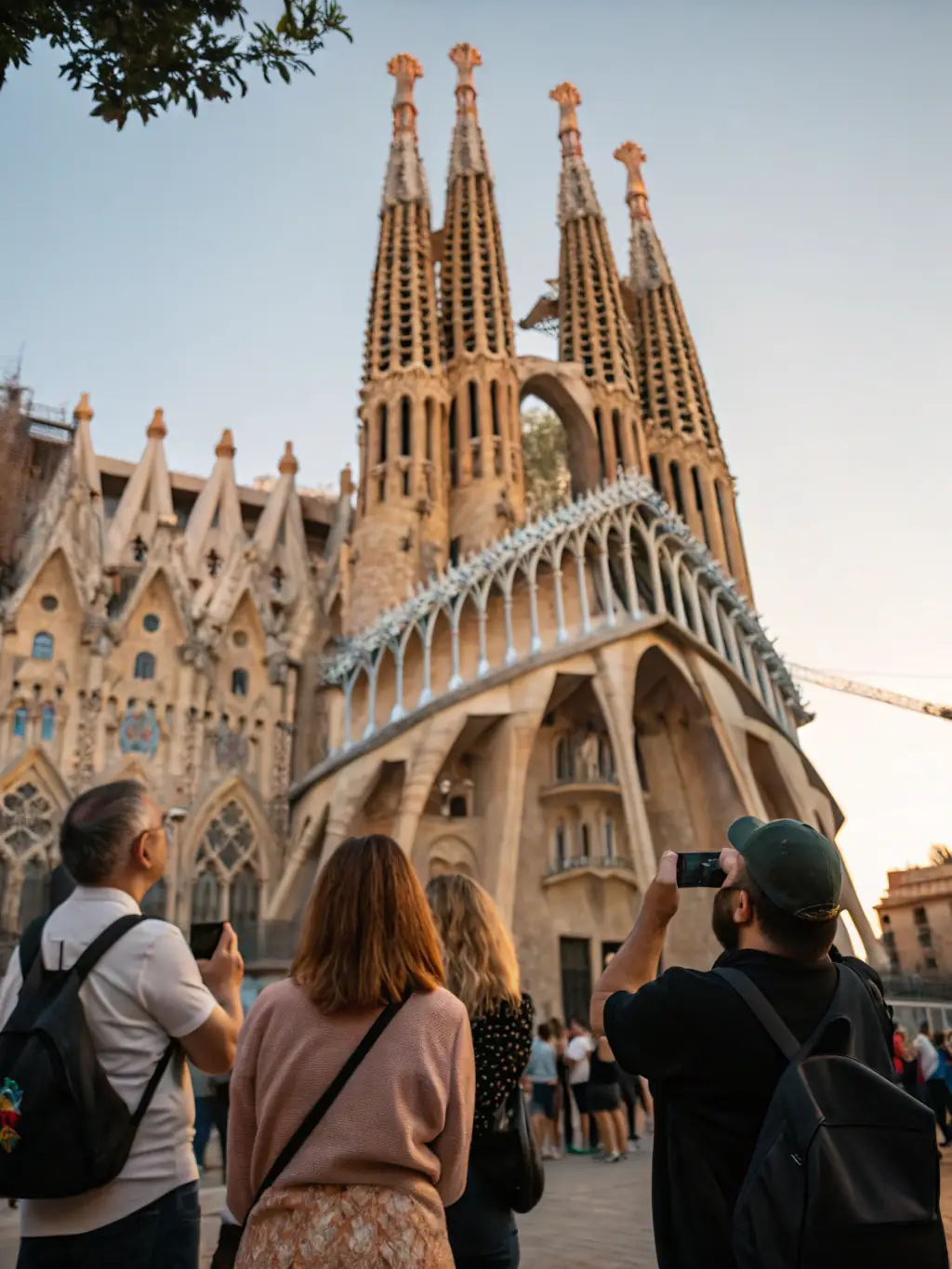 A group of international students taking photos of Gaudí’s Sagrada Familia in Barcelona, with cameras in hand and creative focus, set against the iconic architecture.