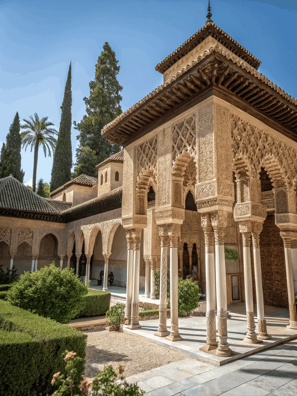 A panoramic view of the Alhambra palace complex in Granada, with the Sierra Nevada mountains in the background, bathed in golden evening light, representing Spain's Moorish heritage for an educational website.