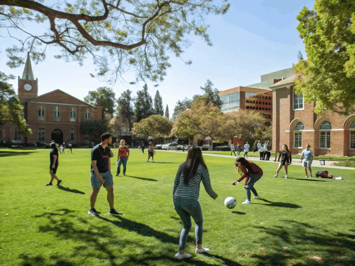 A vibrant group of international students participating in a summer arts and sports camp in Spain, with students painting, playing tennis, and engaging in group activities under sunny skies.